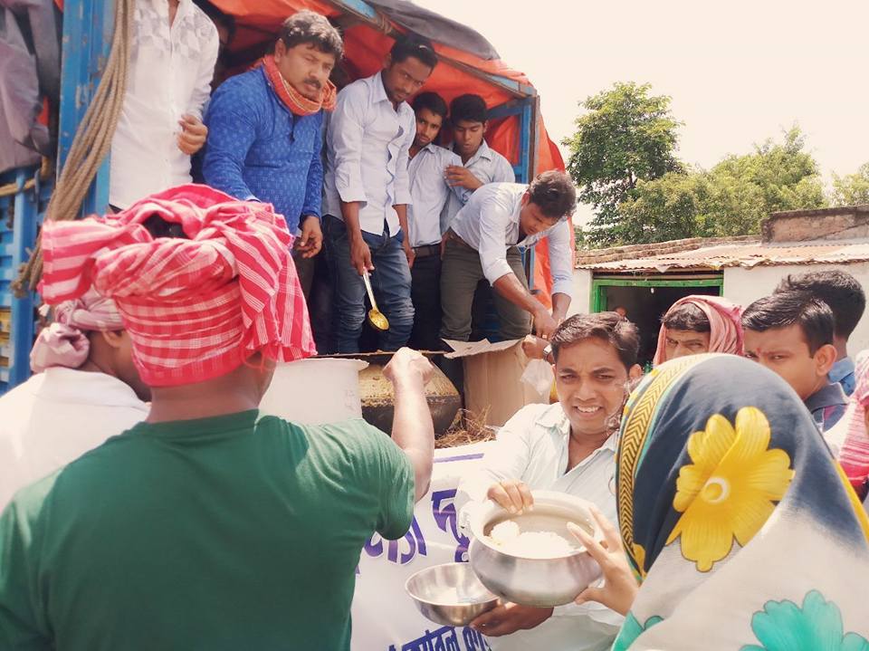 Volunteers serving food to flood victims